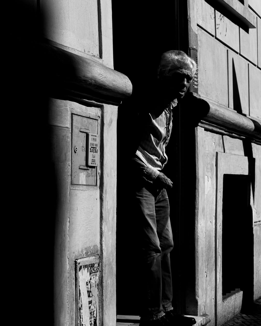 A man leaning out of a doorway
