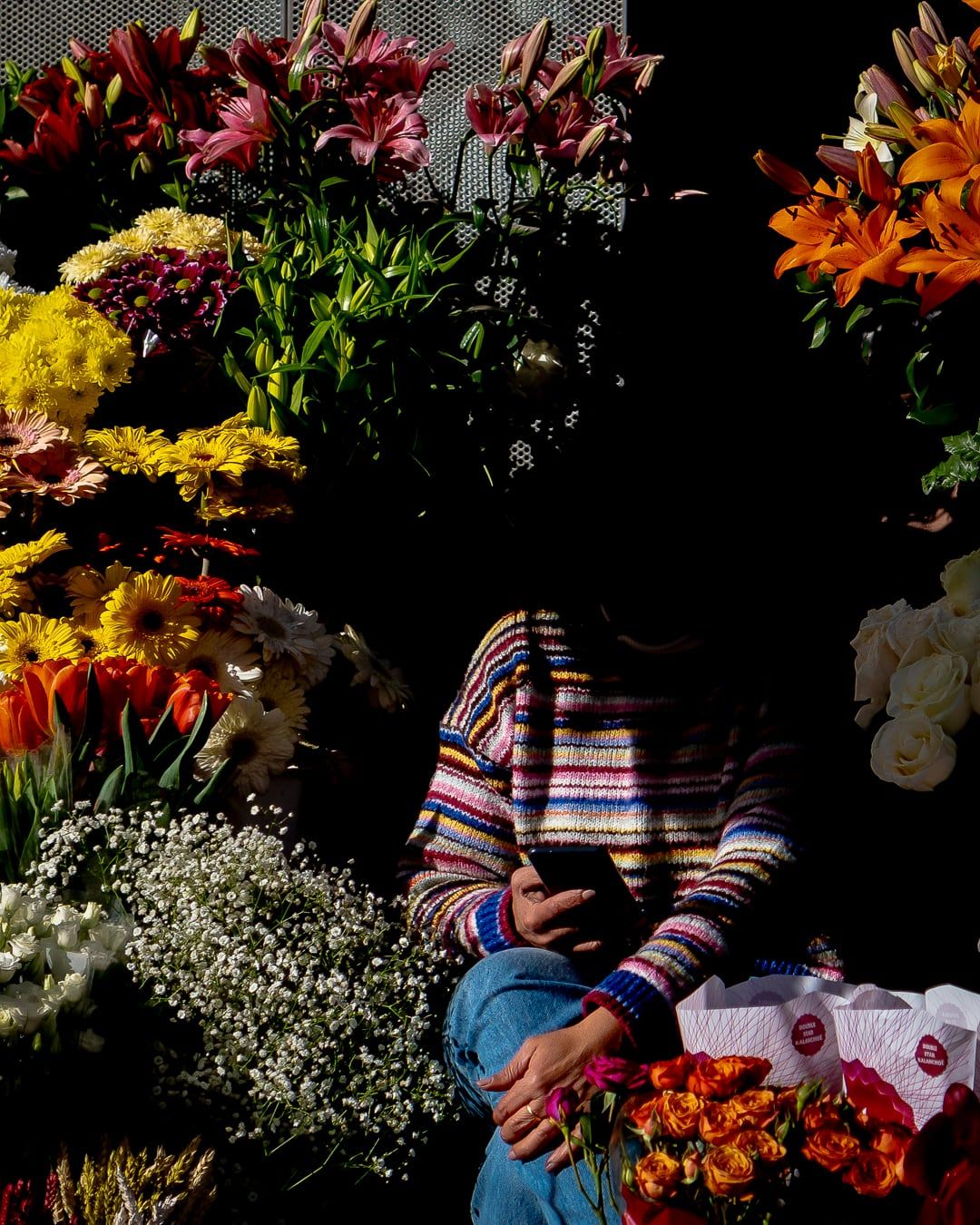 A flower seller among bouquets