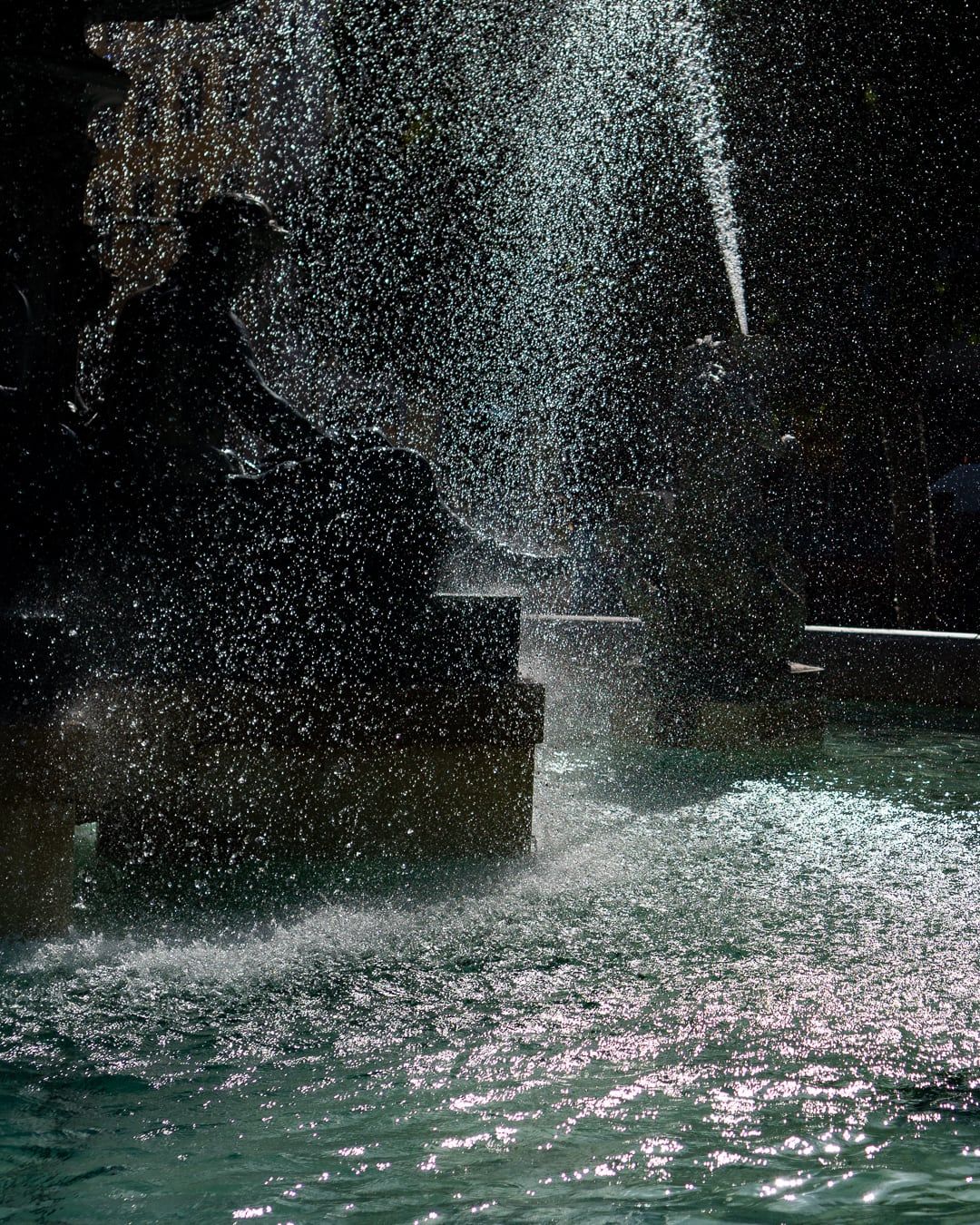 Fountain spray over teal water