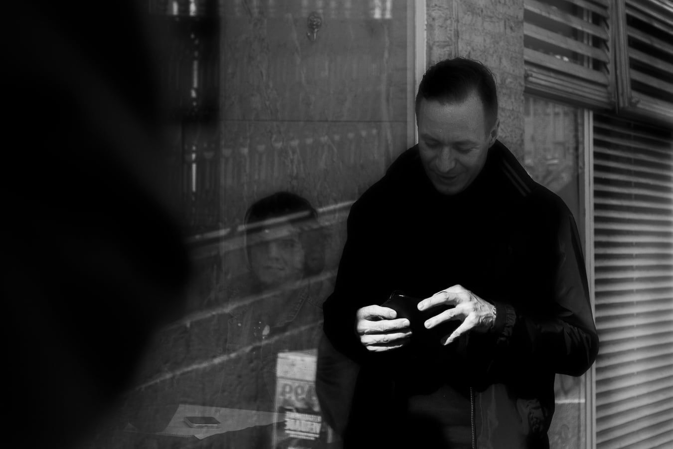 A man on the phone, seen through a window