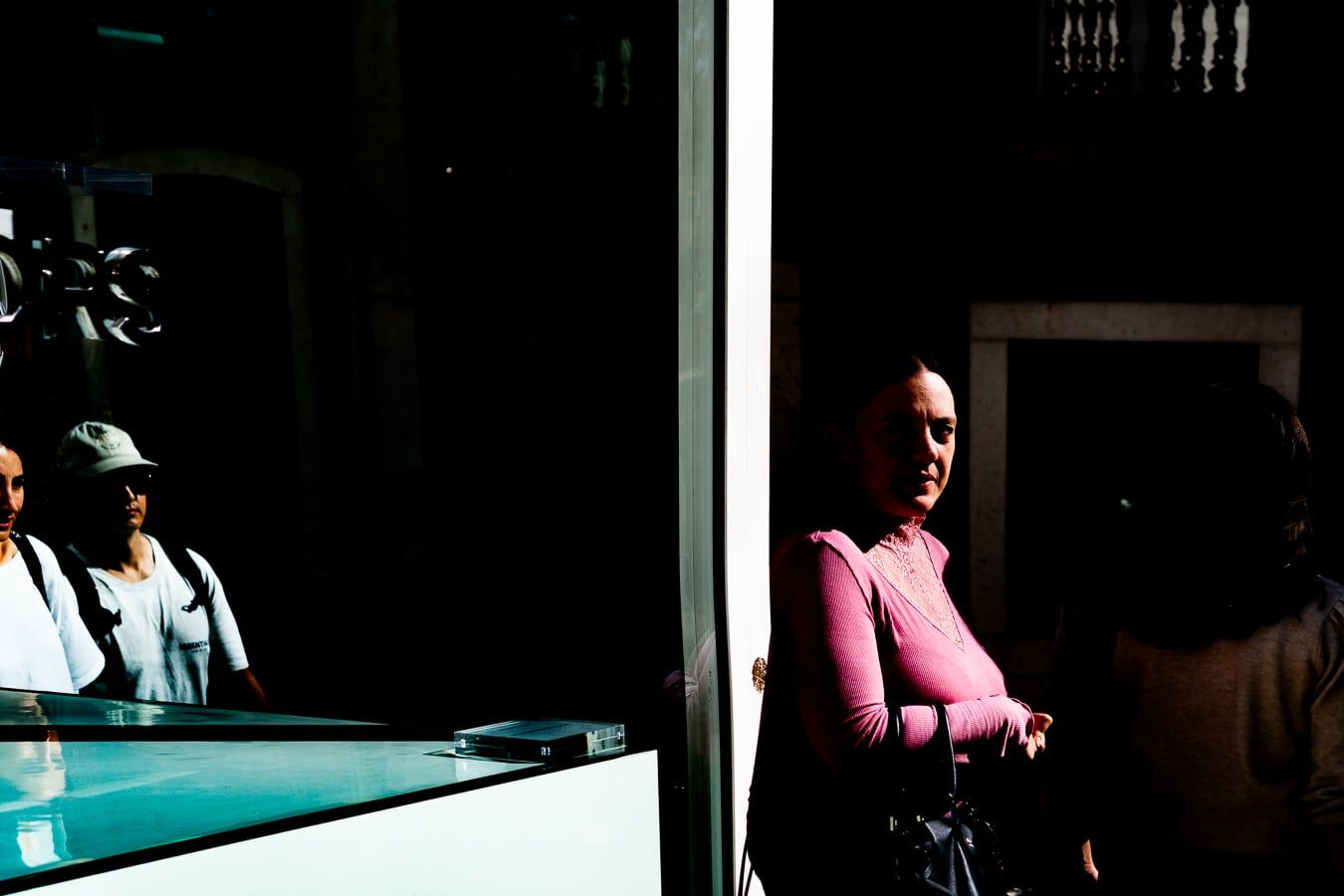 A woman in pink at a counter
