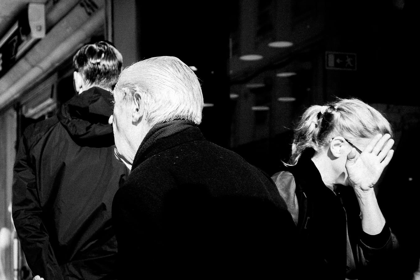 An old man at a shop in a crowd