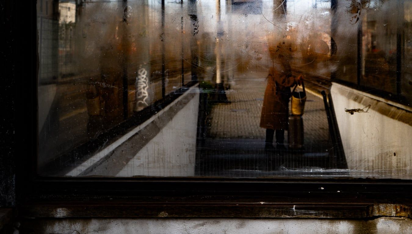 A figure reflected in a window